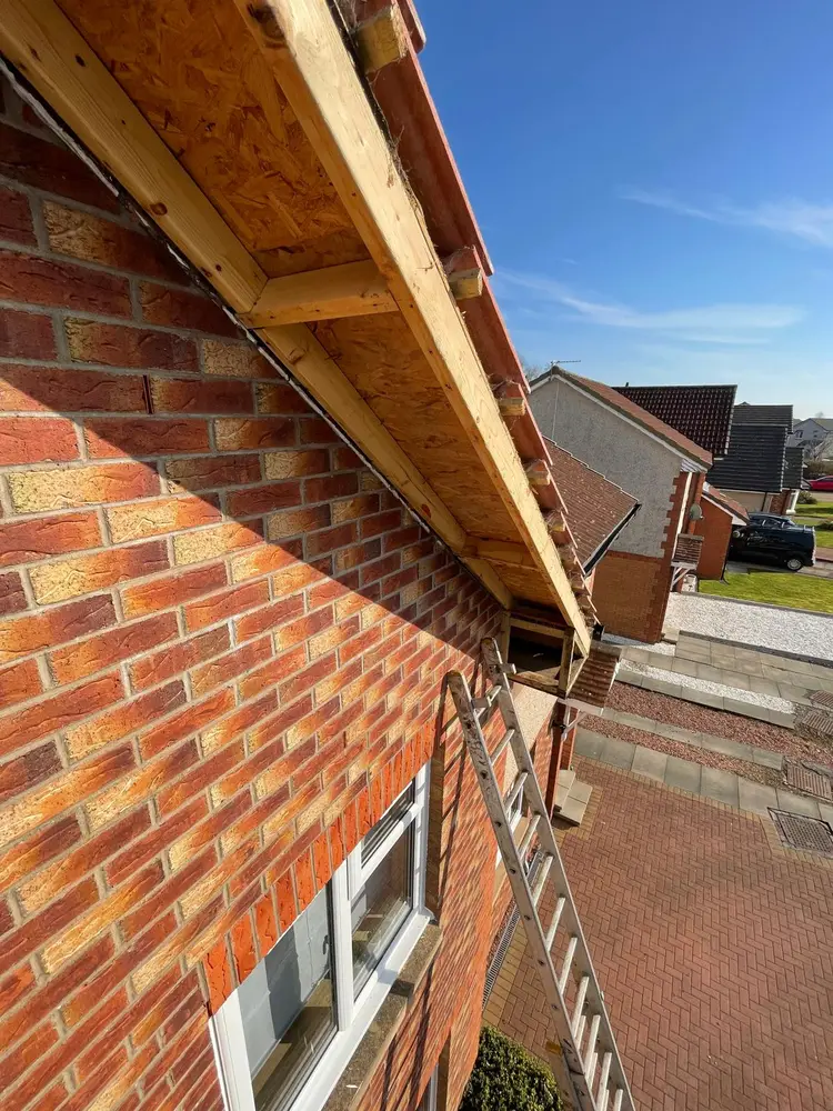 Gable end stripped to bare timber at the roof edge, ready fo Gable end stripped to bare timber at the roof edge, ready for new uPVC fascia boards
